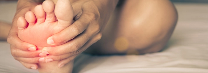 A person holding their foot.