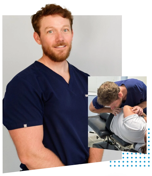 Adam Roussel smiling while wearing dark blue scrubs.