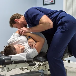 Adam Roussel performing an adjustment.